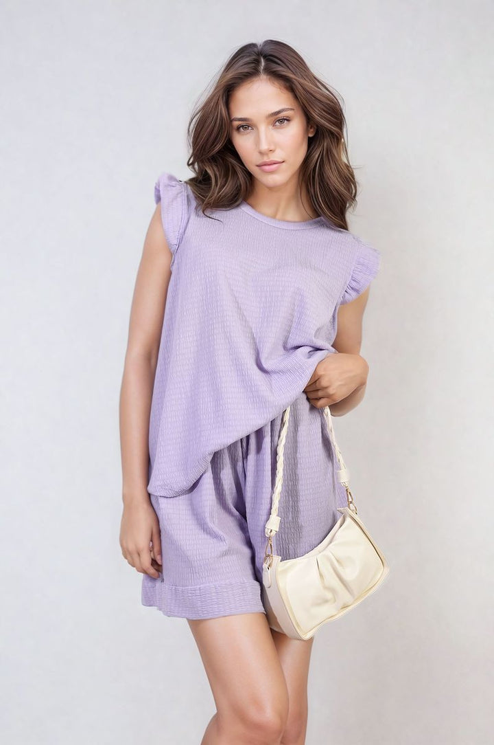 Woman modeling Layla Ruffle Trim Sleeve Top and Shorts Co-ord Set, featuring elegant ruffle sleeves and high-waisted shorts, ideal for chic summer occasions.