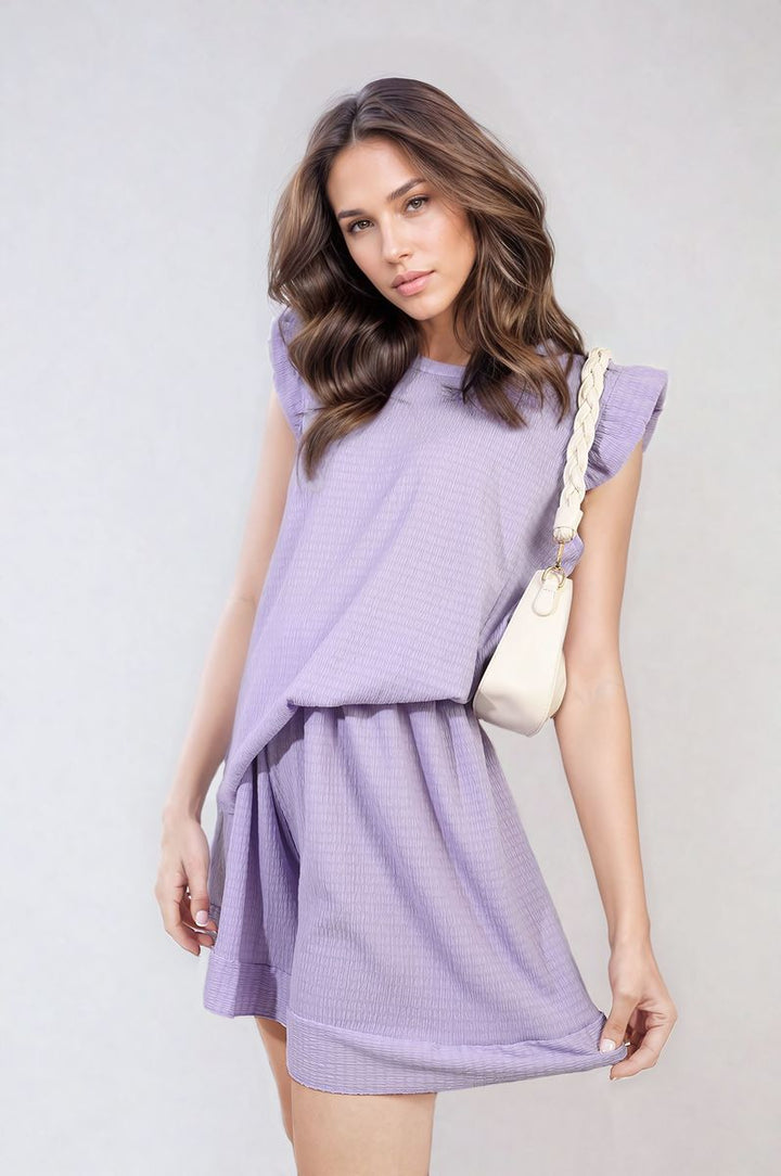 Woman modeling Ruffle Trim Sleeve Top and Shorts Co-ord Set, showcasing ruffle sleeves and high-waisted shorts, embodying chic summer style.