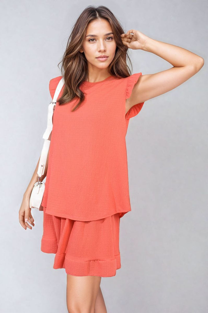 Woman modeling Layla Ruffle Trim Sleeve Top and Shorts Co-ord Set, featuring ruffle sleeves and high-waisted shorts. Perfect for chic, versatile summer style.