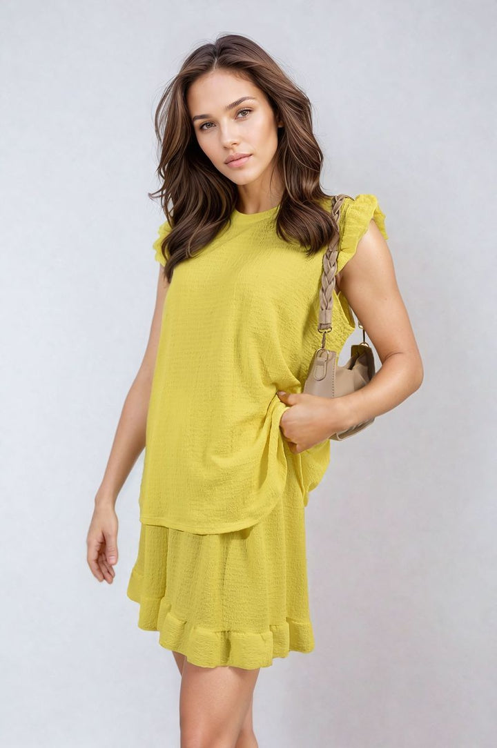 Woman in Ruffle Trim Sleeve Top and Shorts Co-ord Set, showcasing its chic, playful design perfect for summer outings.