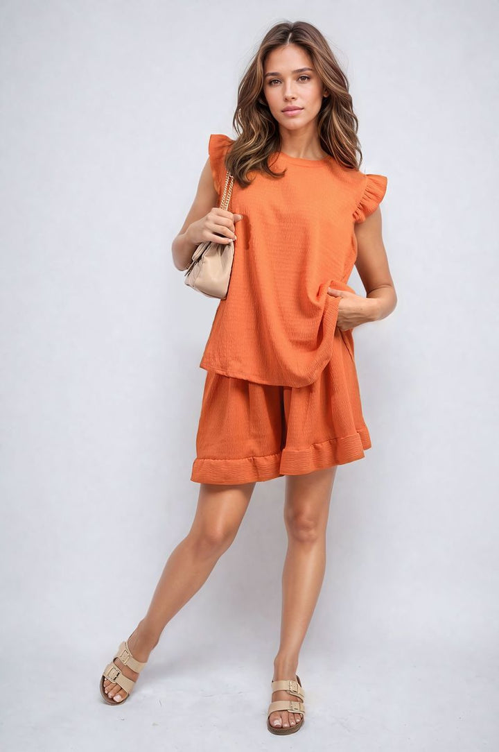 Woman in a Ruffle Trim Sleeve Top and Shorts Co-ord Set, showcasing chic, playful style perfect for summer outings and holiday wardrobes.