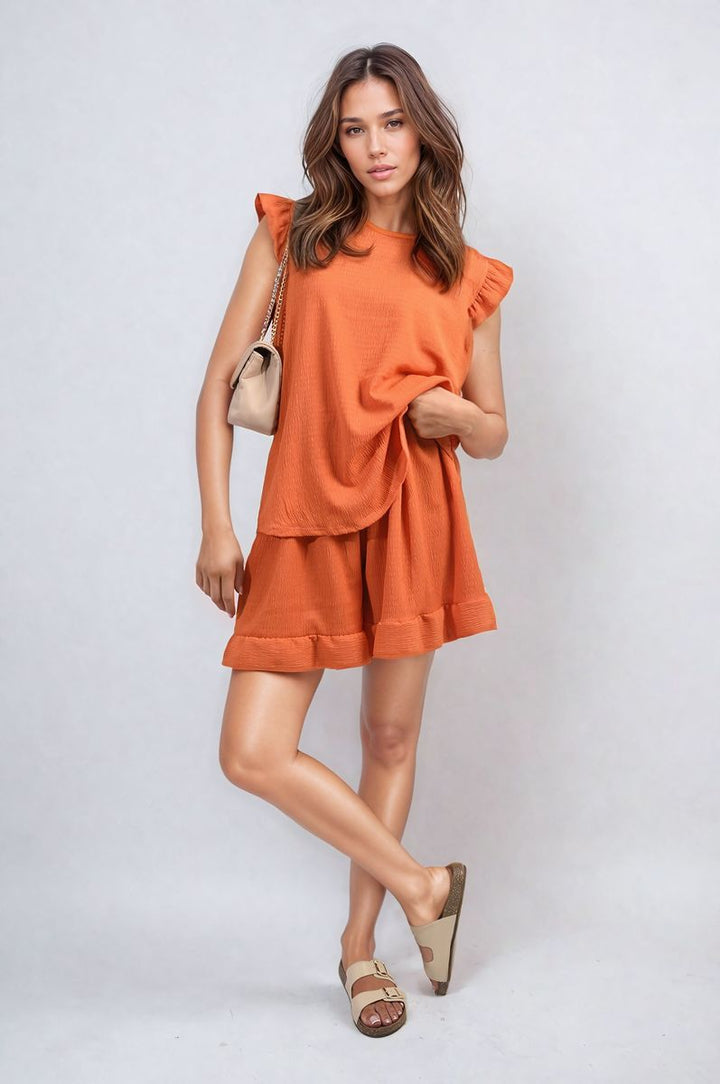 Woman modeling Ruffle Trim Sleeve Top and Shorts Co-ord Set, showcasing stylish summer fashion with ruffle sleeves and high-waisted shorts from Holiday Clothes UK.