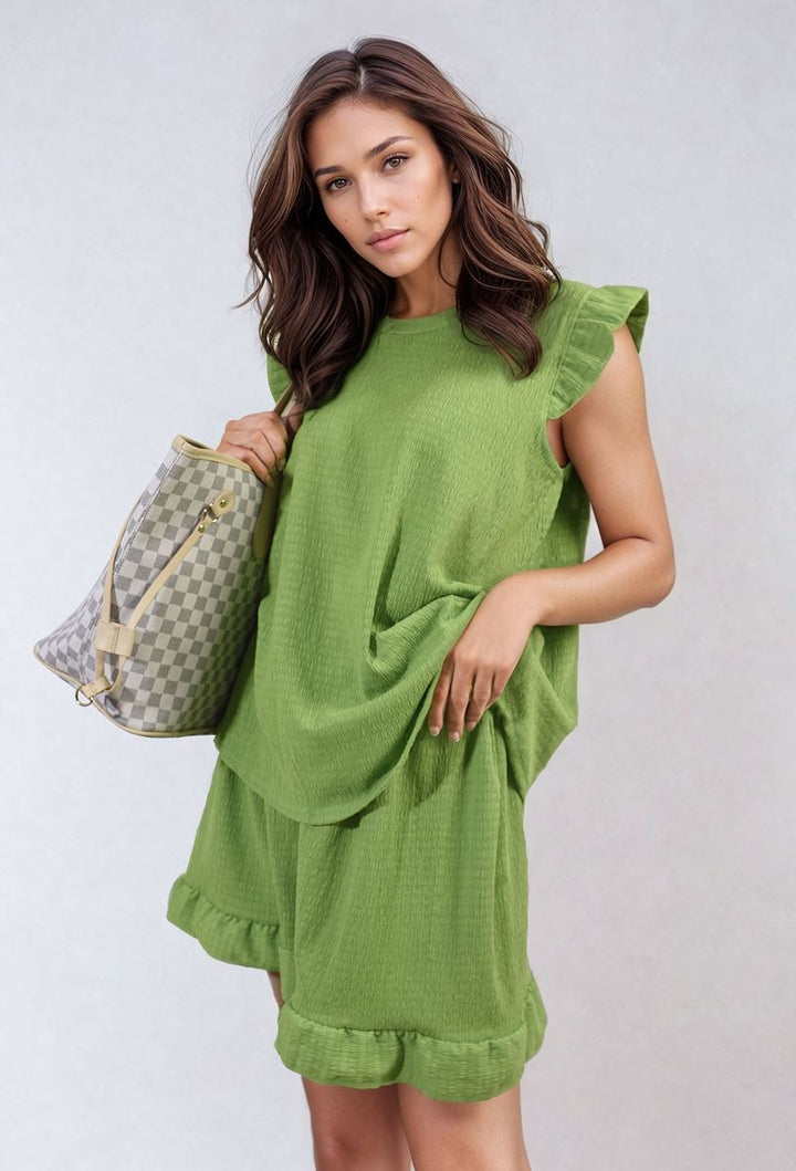 Woman wearing Ruffle Trim Sleeve Top and Shorts Co-ord Set, holding a checkered purse, showcasing the outfit's chic and playful design.