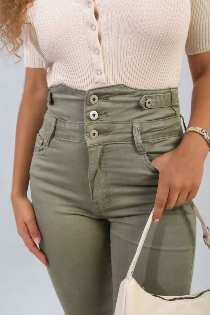 High Waist Button Skinny Jeans showcased on a woman, paired with a white shirt and green pants, highlighting the jeans' flattering fit and modern design.