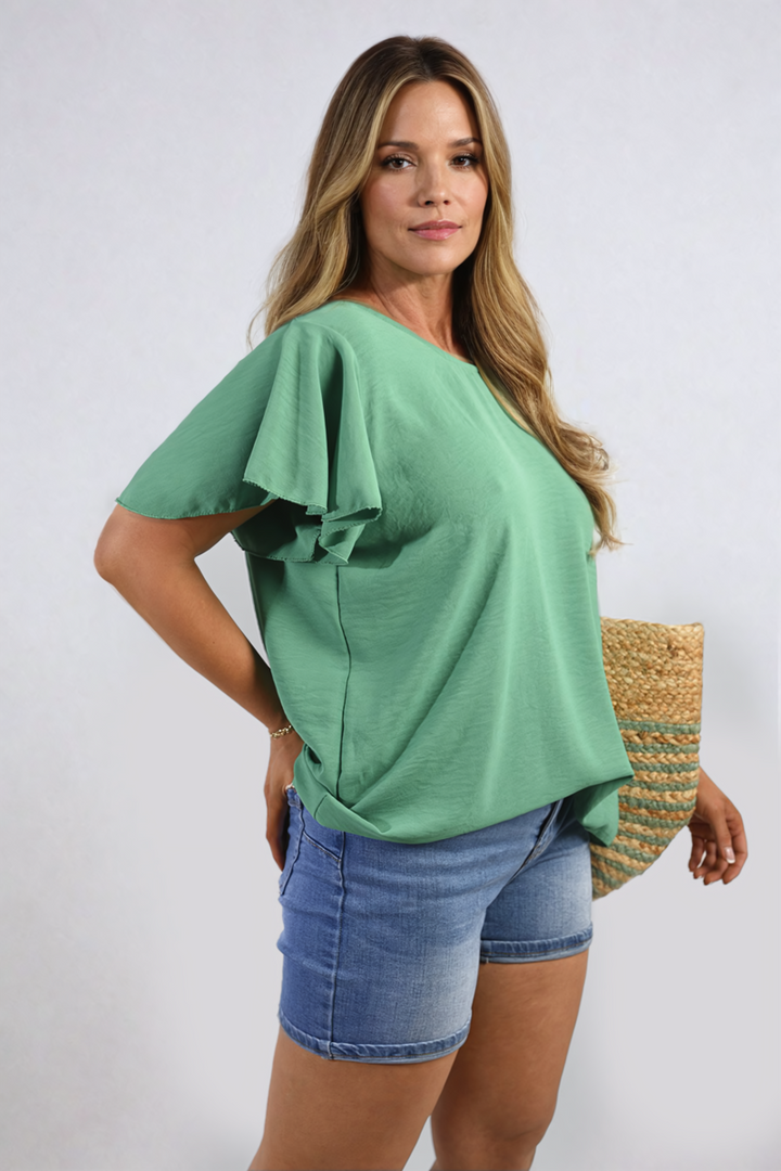 Woman wearing Leilani Ruffle Short Sleeve Top with ruffled sleeves, showcasing a stylish and feminine design perfect for casual or dressy occasions.