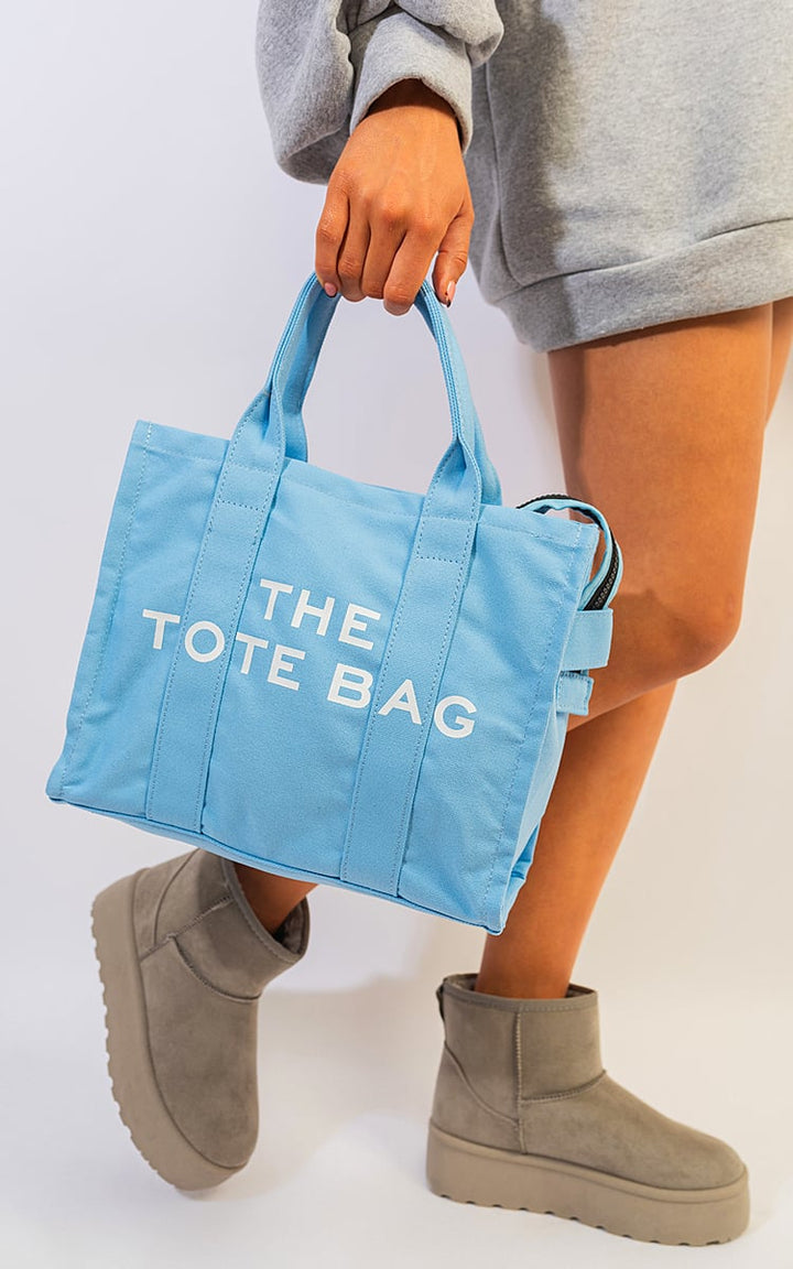 Letter Pattern Canvas Shoulder Shopper Tote Bag held by a person, showcasing its spacious design and practical shoulder straps for stylish, everyday use.