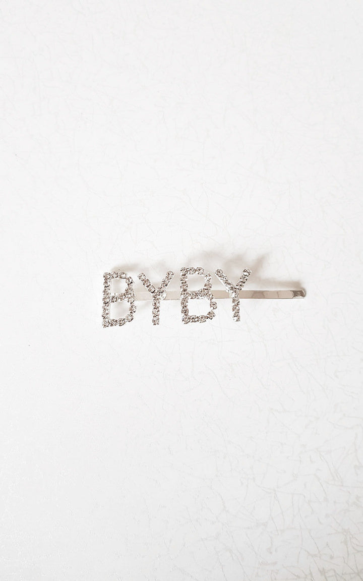 Slogan Diamante Detail Hair Clip with 'BYBY' letters on a silver-plated clip, ideal for adding a stylish touch to holiday outfits.