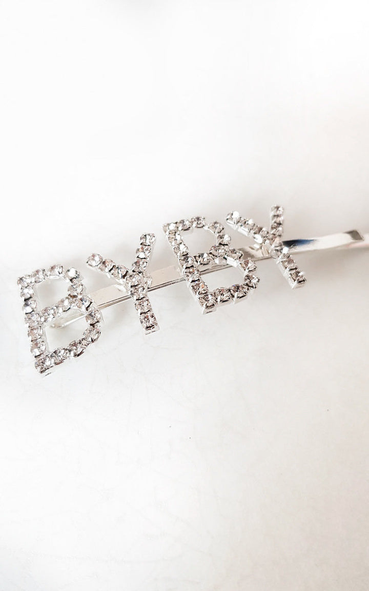 Slogan Diamante Detail Hair Clip: Silver-plated clip adorned with 'BYBY' diamante detail, perfect for adding a touch of elegance to any outfit.