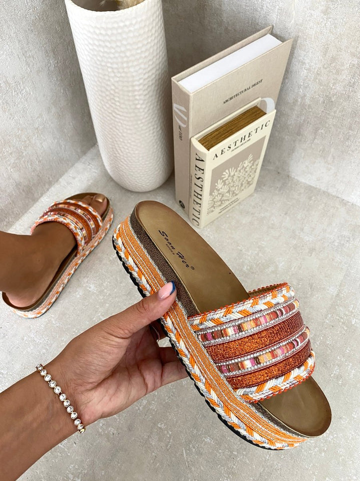 Hand holding the Lilian Thick Wedge Heel Braided Platform Sandals, showcasing their substantial wedge and braided design, perfect for stylish summer outings.