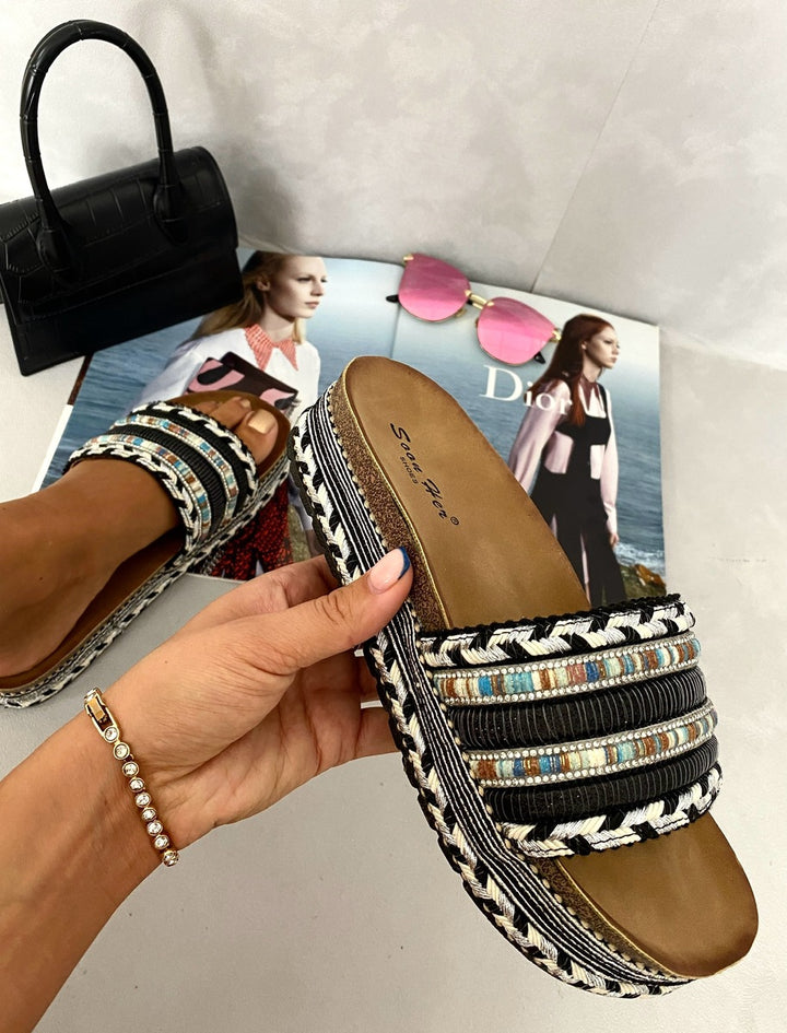 Hand holding Thick Wedge Heel Braided Platform Sandals, showcasing their substantial wedge heel and braided platform, ideal for stylish summer outings.