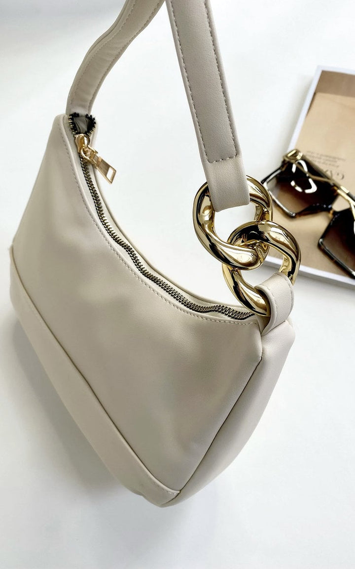 White purse with gold chain detail, perfect for a night out. Made of durable faux leather, ideal for carrying essentials on special occasions.