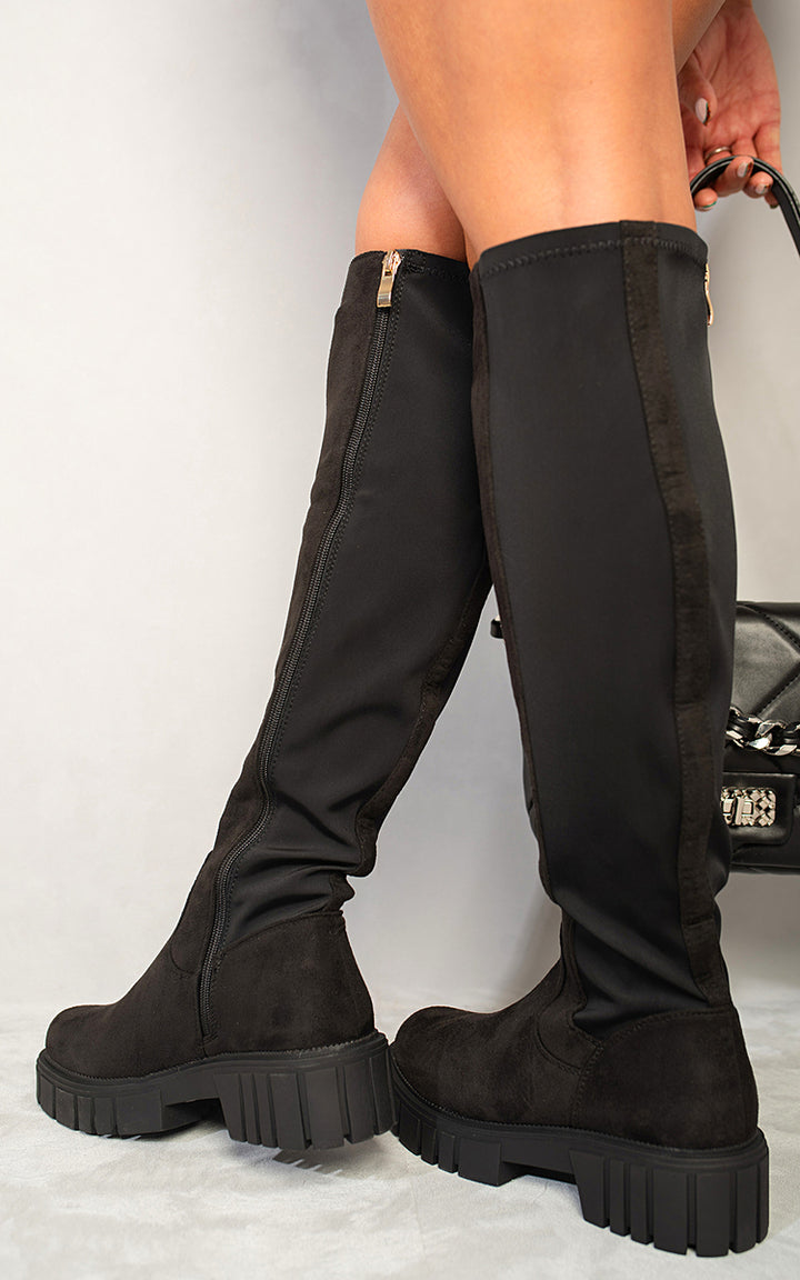 Knee High Chunky Boots with chunky heels, showcased on a person, perfect for elevating style and comfort in everyday wear.