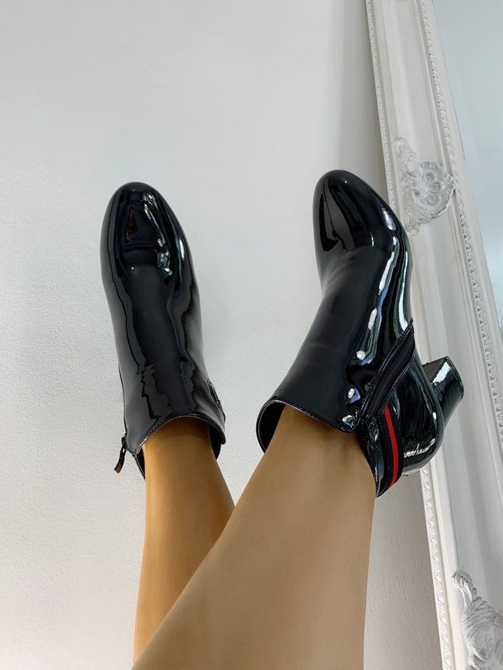 Patent Heeled Ankle Boots with shiny faux leather, block heel, red side stripe, and side zip, perfect for transitioning from day to night.