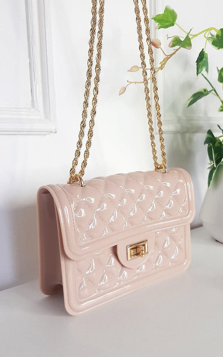 Quilted Chain Detail Handbag with gold fastenings and chic quilted design displayed on a shelf, perfect for elevating any outfit.