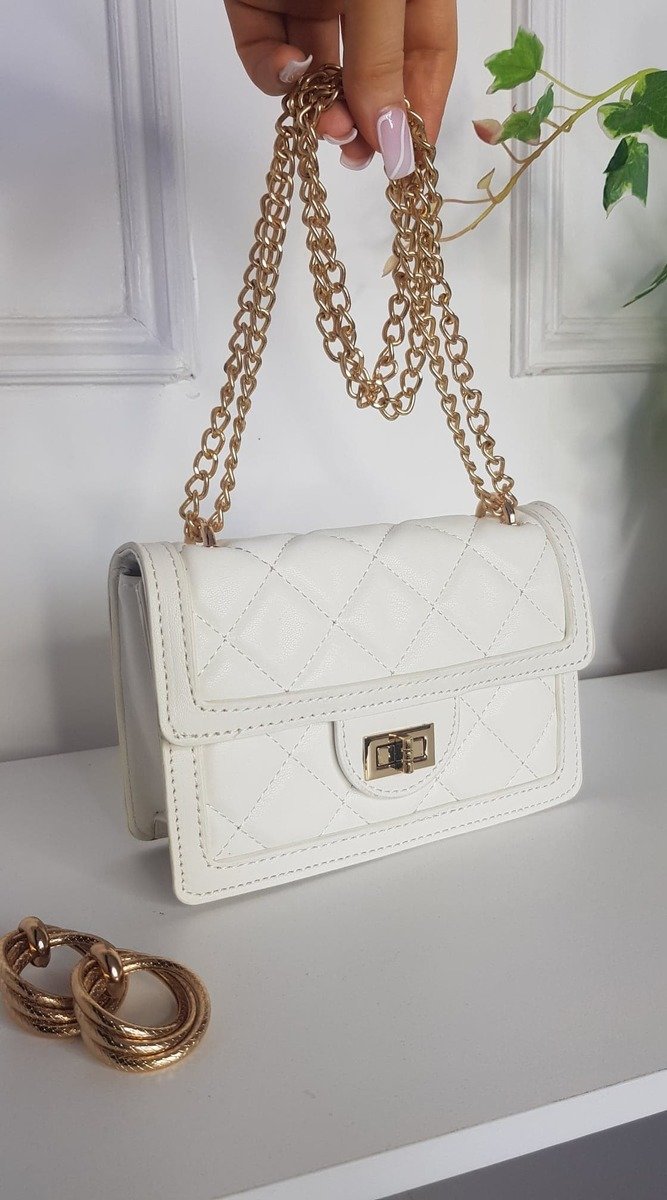 Quilted Chain Detail Handbag with gold chains and fastenings, showcasing chic design and faux leather material, ideal for complementing stylish holiday outfits.