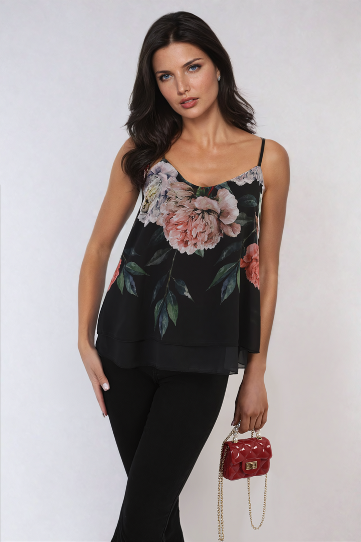 Woman wearing a Luciana Floral Print Layered Cami Top, holding a red purse, showcasing a stylish, casual outfit perfect for everyday wear.