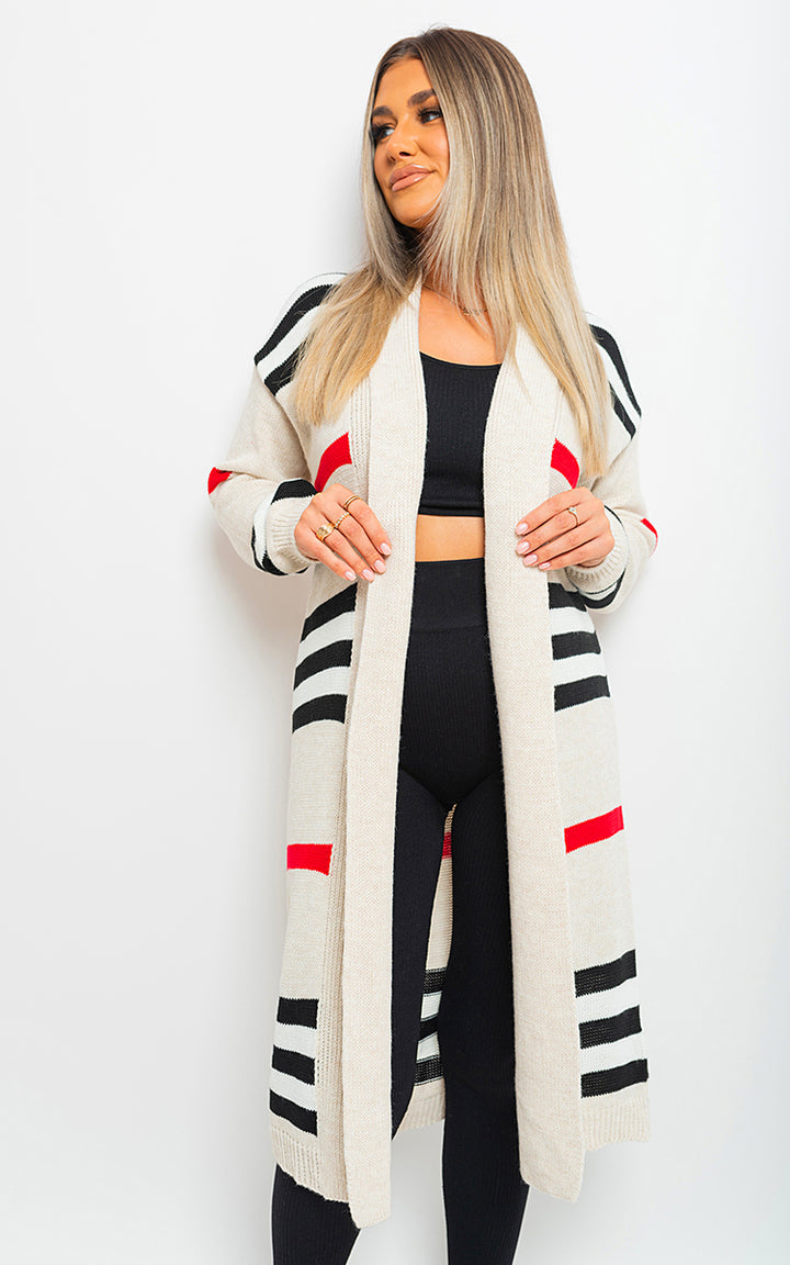 Woman wearing the Luna Oversized Long Striped Knitted Cardigan with black leggings, showcasing its chic striped design and relaxed fit.