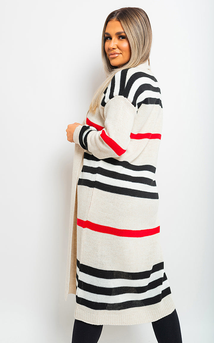 Woman wearing an oversized long striped knitted cardigan, showcasing its relaxed fit and chic striped pattern, ideal for stylish casual wear.