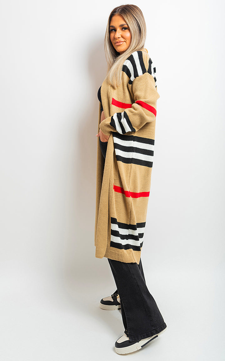 Woman wearing the Oversized Long Striped Knitted Cardigan, showcasing its chic, relaxed fit and timeless striped pattern, perfect for stylish layering.