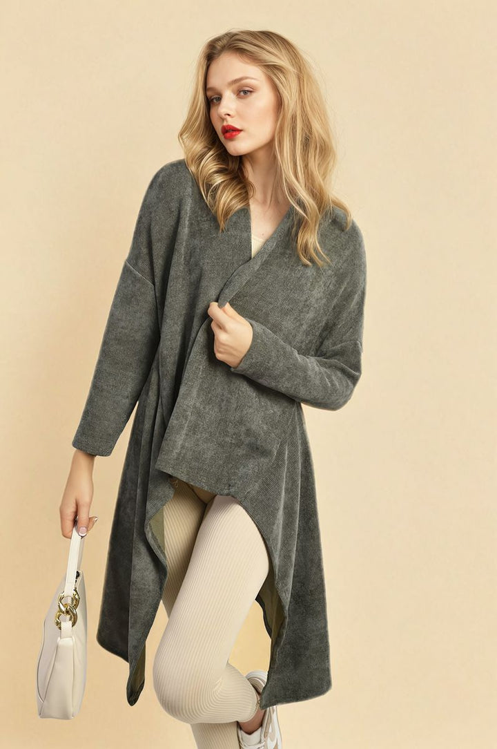 Woman wearing the Lydia Open Front Long Back Knitted Cardigan, holding a white purse, showcasing a cozy, stylish look perfect for casual or dressed-up occasions.