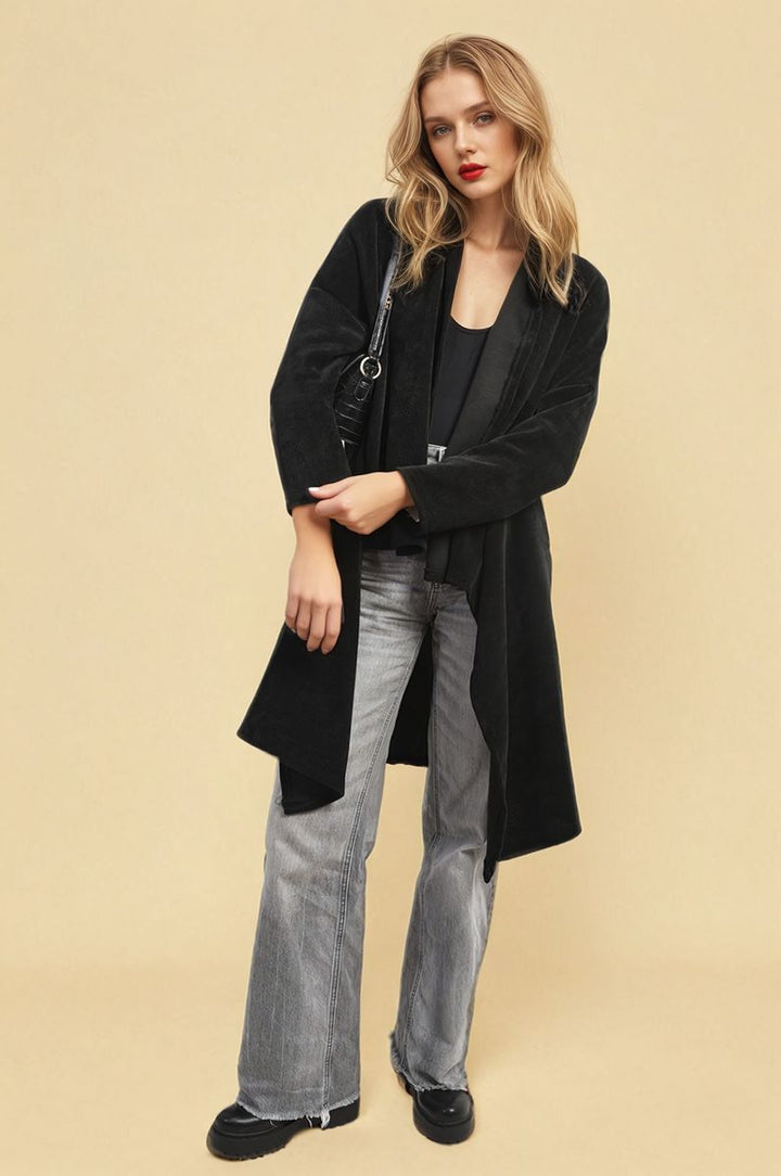 Woman wearing the Lydia Open Front Long Back Knitted Cardigan, showcasing its flowy design and cozy knit, ideal for stylish, effortless layering.