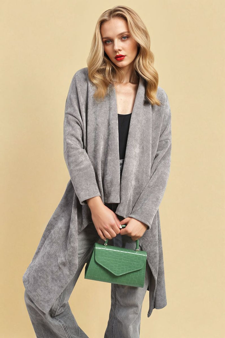 Woman wearing an Open Front Long Back Knitted Cardigan, holding a green purse, showcasing a versatile and chic style from Holiday-clothes.co.uk.