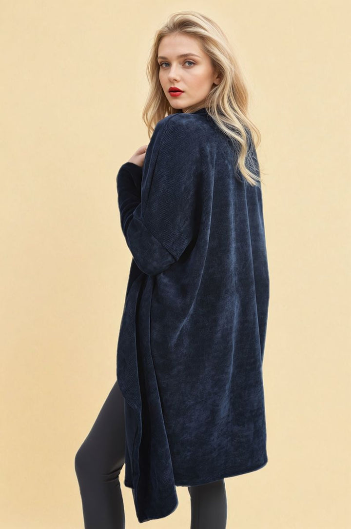 Woman wearing the Open Front Long Back Knitted Cardigan, showcasing its flowy design and cozy knit, ideal for stylish versatility in everyday wear.