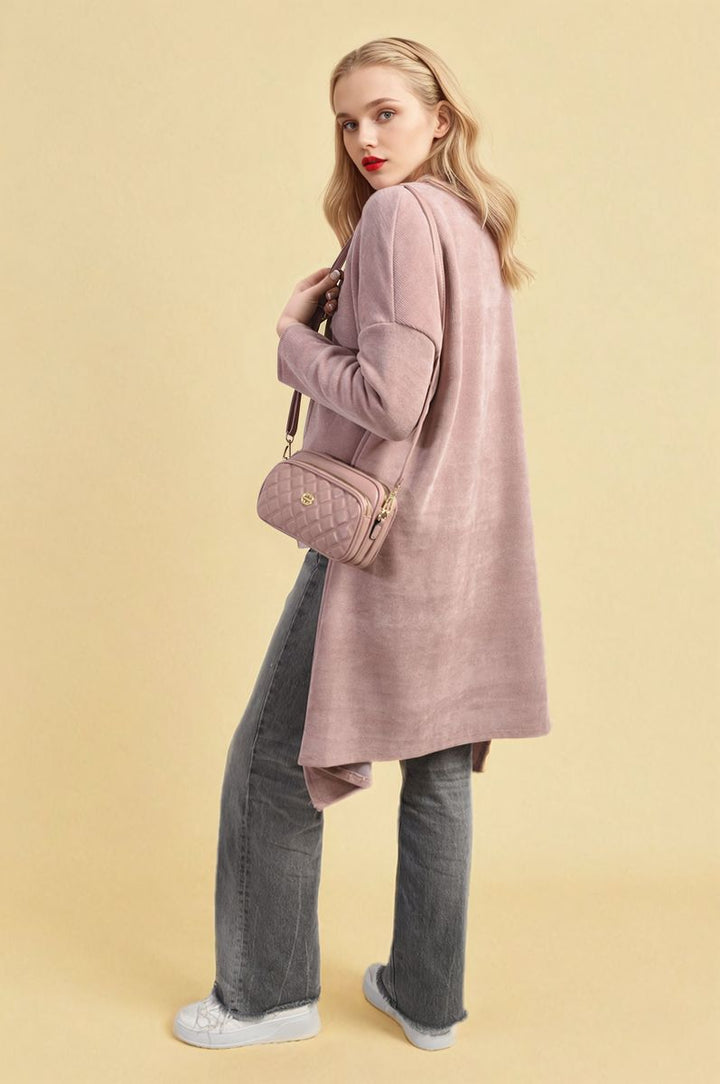 Woman wearing an Open Front Long Back Knitted Cardigan, showcasing its flowy design and cozy knit, ideal for stylish layering and everyday wear.