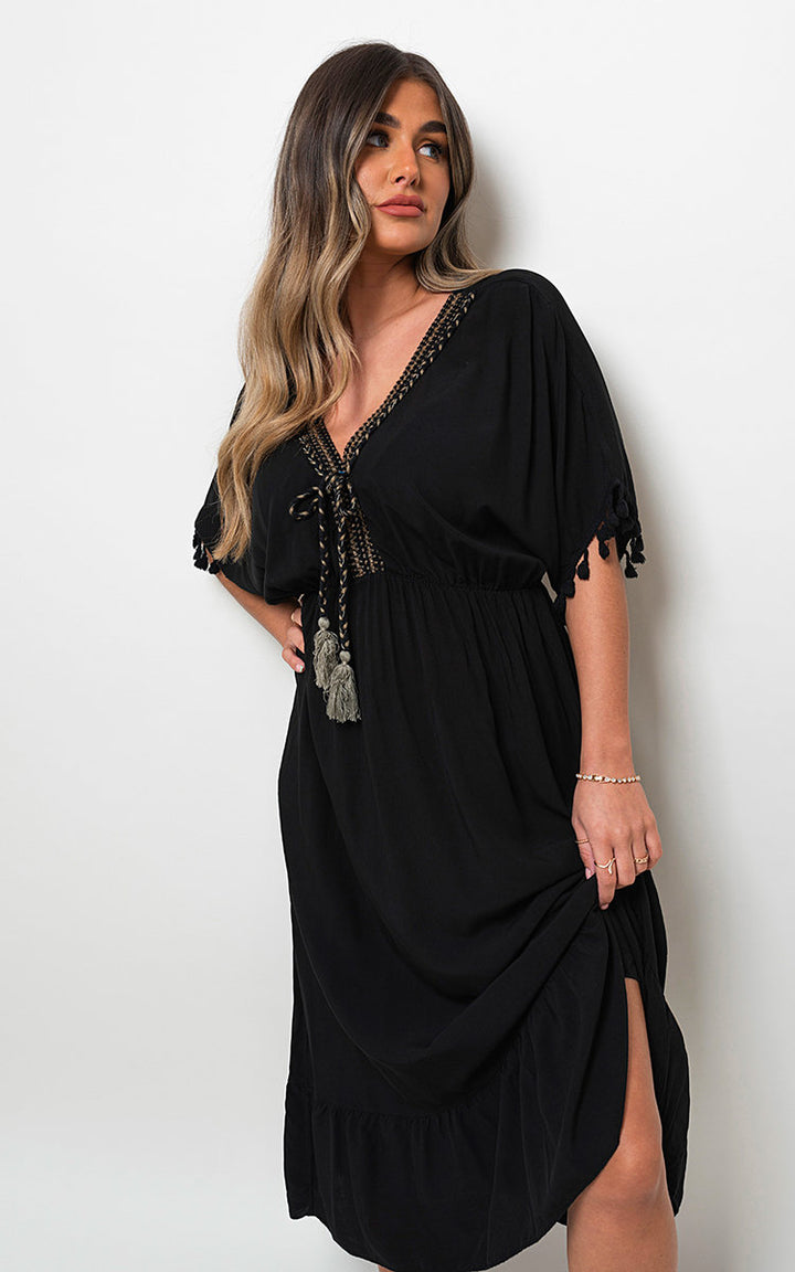 V-Neck Rope Tassel Detail Maxi Dress worn by a model, showcasing its elegant neckline and bohemian rope tassel accents, ideal for various occasions.