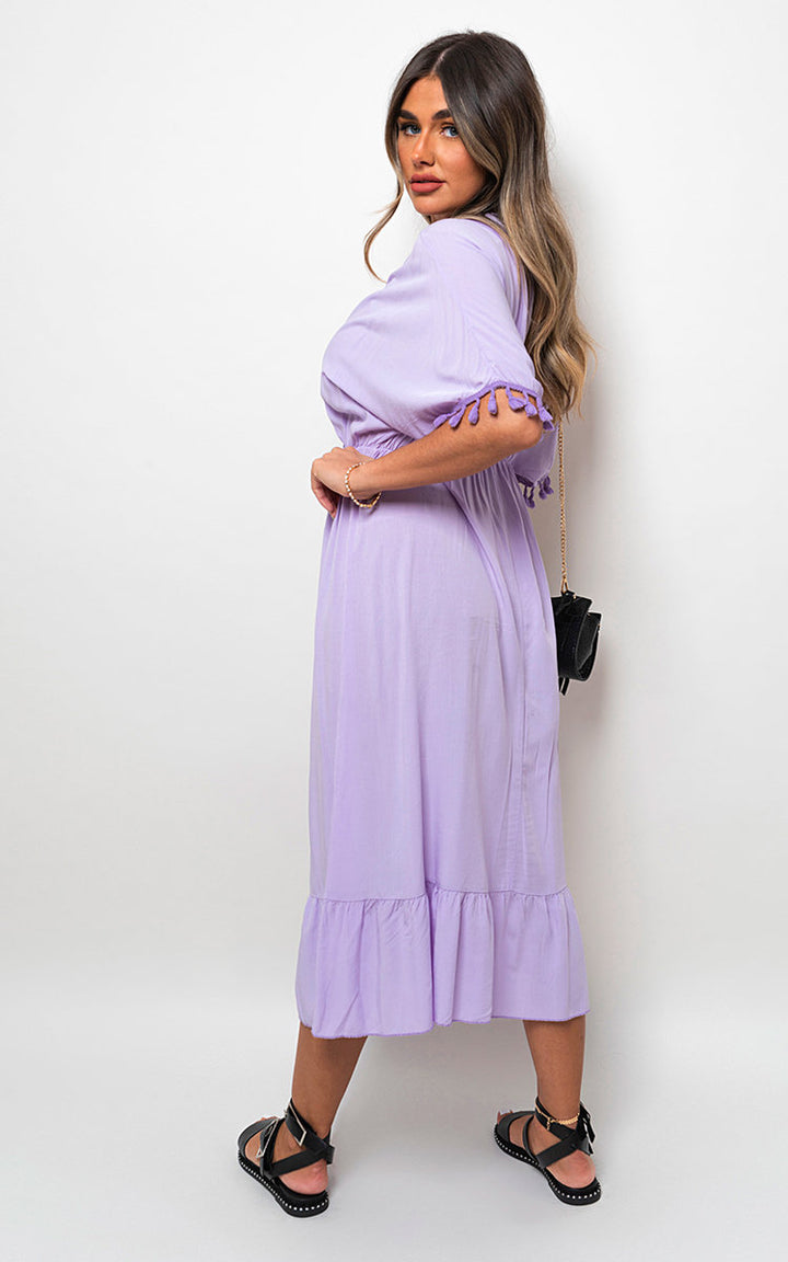 V-Neck Rope Tassel Detail Maxi Dress featuring a bohemian design, worn by a woman, highlighting its elegant silhouette and unique tassel features.