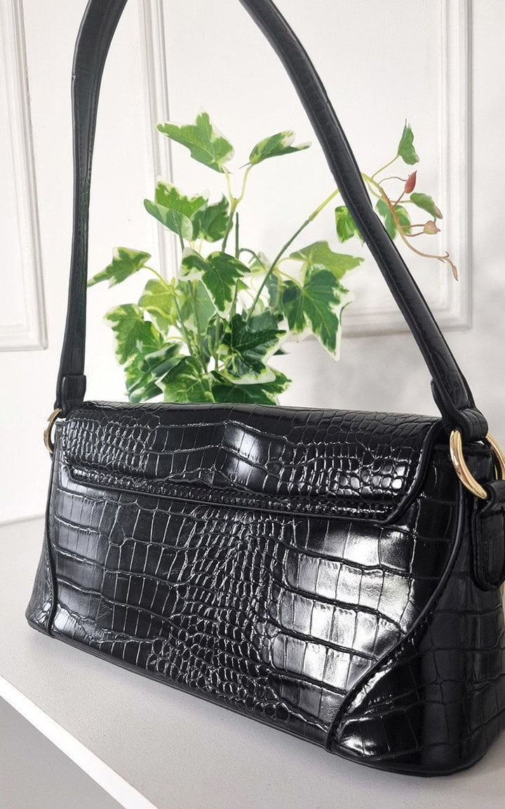 Faux Leather Croc Print Handbag sitting on a shelf, ideal for everyday use or special occasions, with a stylish and durable design.