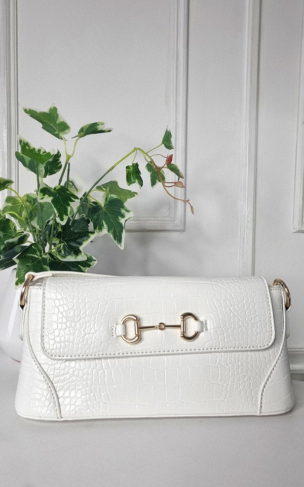 Faux Leather Croc Print Handbag displayed beside a plant, showcasing its stylish and versatile design, ideal for everyday use or special occasions.