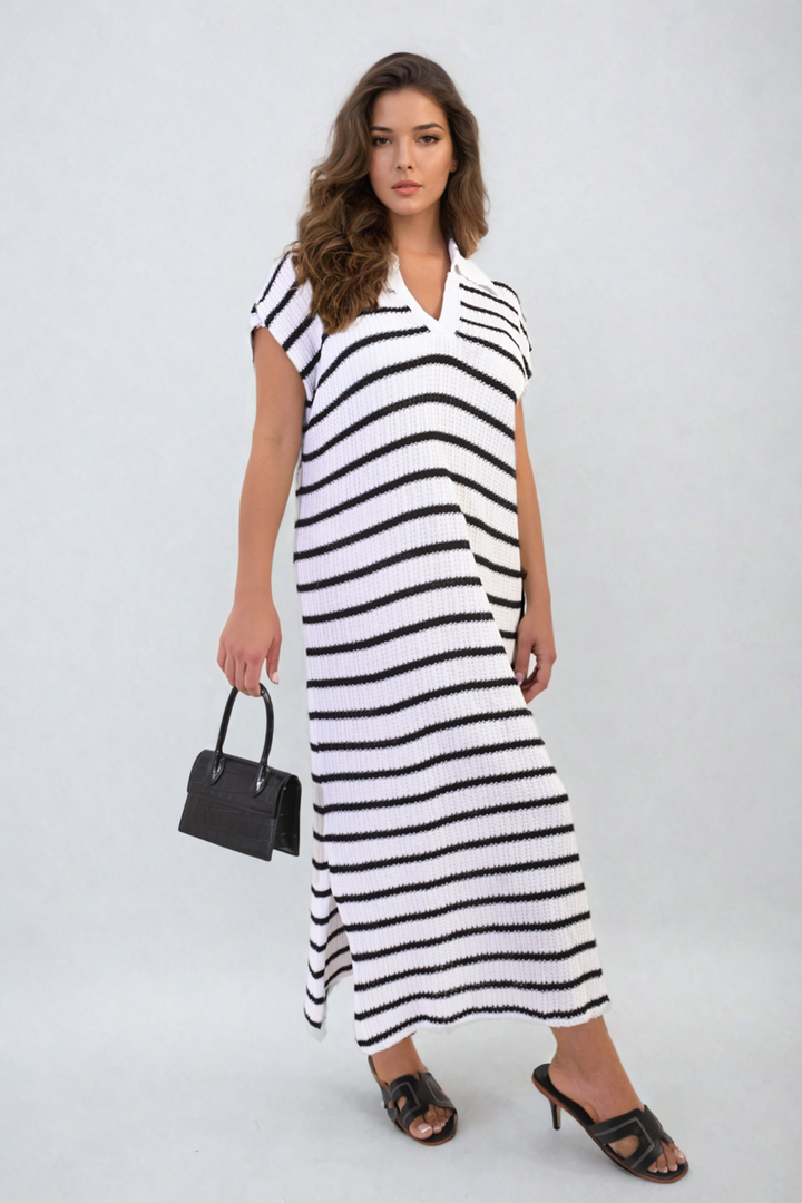 Woman in a Stripe Knitted V Neck Midi Dress holding a black handbag, showcasing chic elegance and sophisticated style, perfect for various occasions.