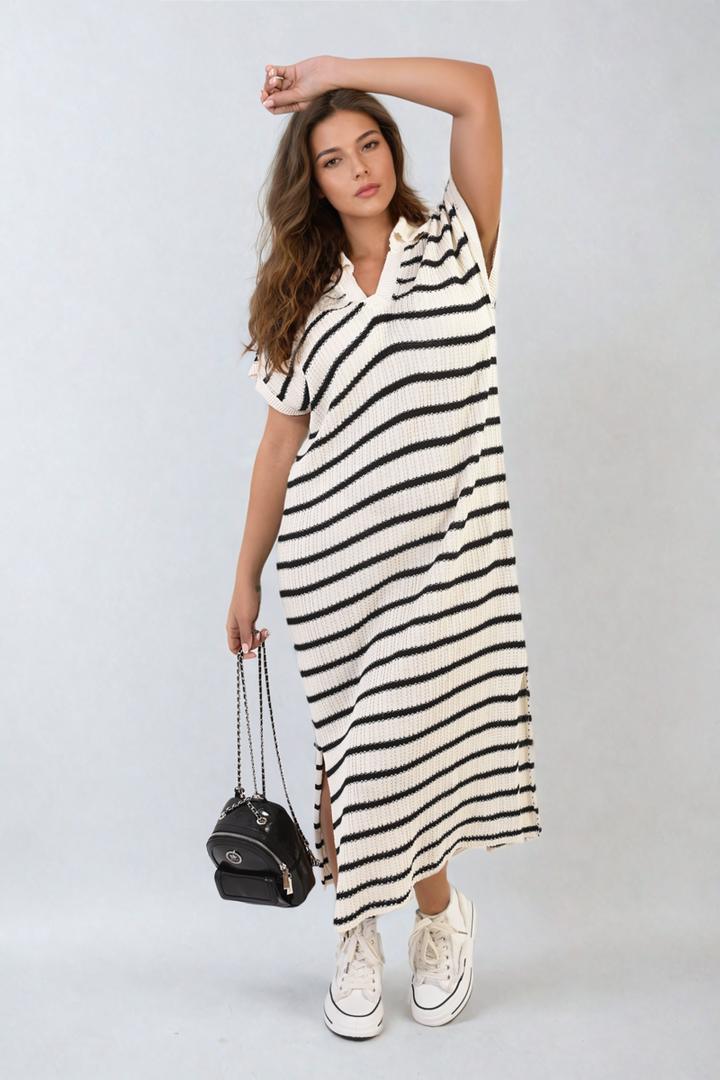 Woman in a Stripe Knitted V Neck Midi Dress holding a black purse, showcasing the dress's stylish silhouette and versatility for casual occasions.