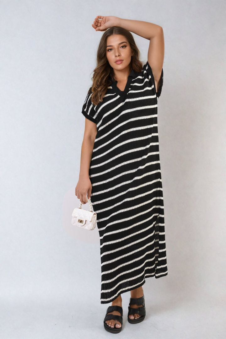 Woman wearing Stripe Knitted V Neck Midi Dress with white bag, showcasing a stylish and versatile look, ideal for both casual outings and elegant occasions.