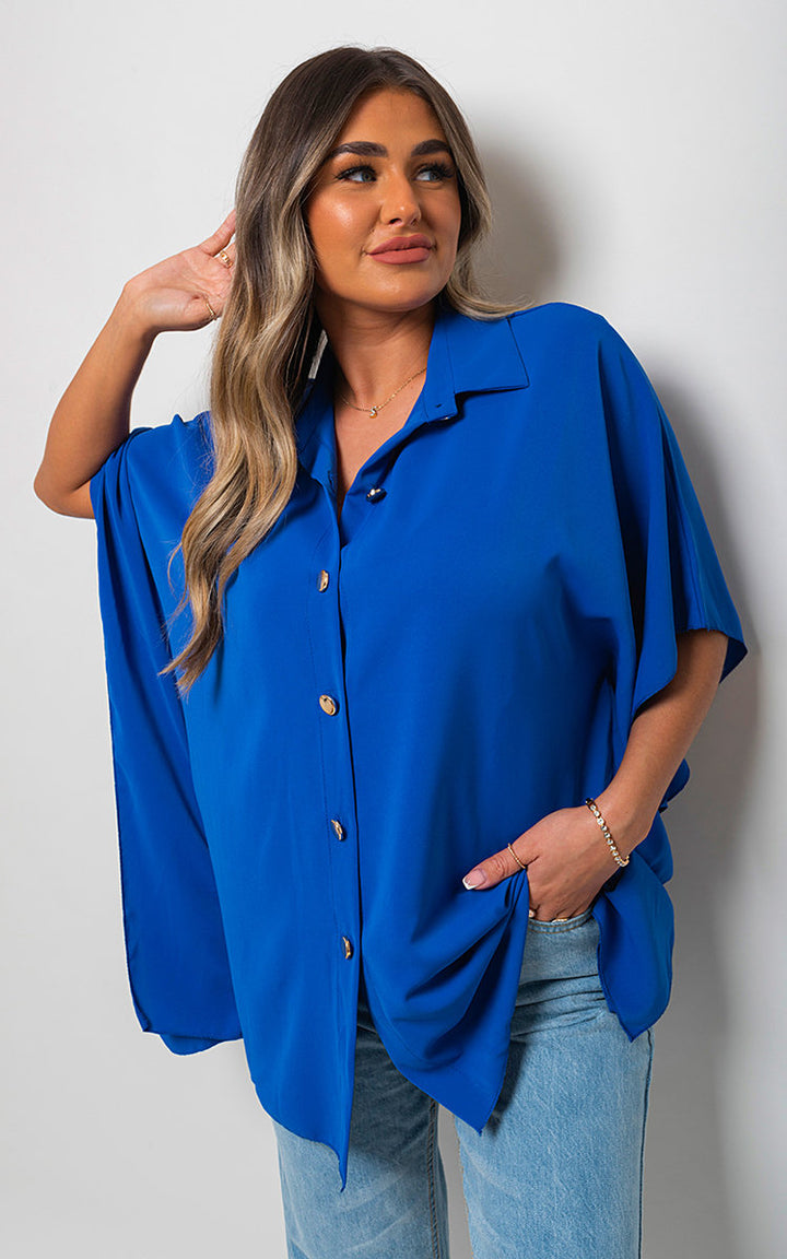 Woman wearing a Margaret Button Down V Neck Casual Loose Top, showcasing its classic v-neckline and loose fit, perfect for everyday comfort and style.