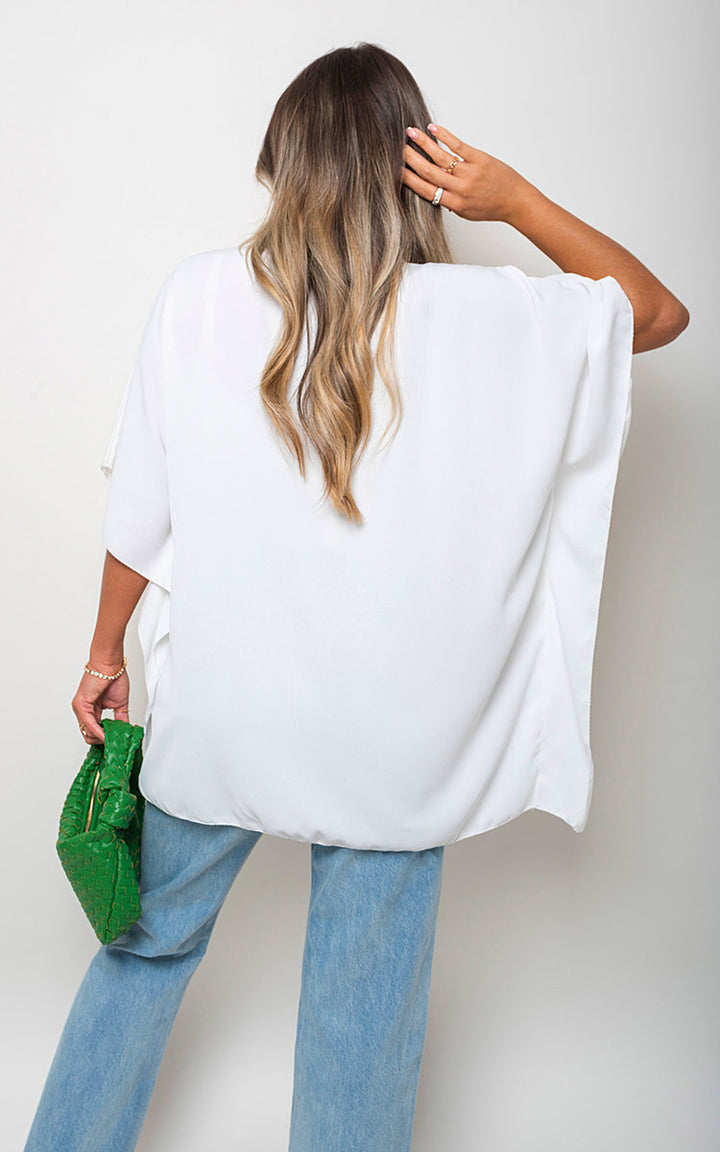 Woman wearing a Margaret Button Down V Neck Casual Loose Top with blue jeans, featuring a classic v-neckline and loose fit, perfect for everyday style.