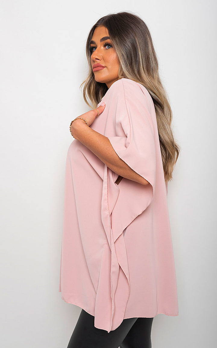 Woman wearing Margaret Button Down V Neck Casual Loose Top, showcasing its v-neckline and loose fit, complemented by a stylish bracelet and pink scarf.