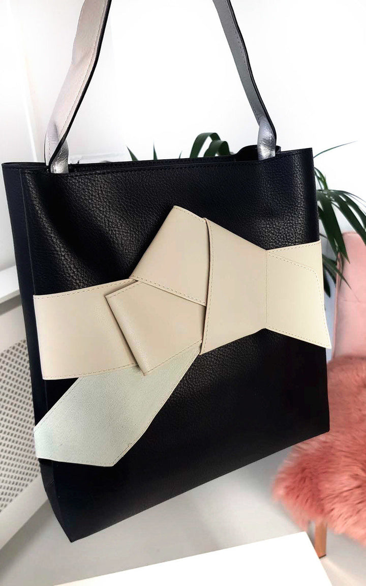 Colour Block Bow Tote Handbag featuring a stylish black and white design with a statement bow, perfect for adding flair to your holiday wardrobe.