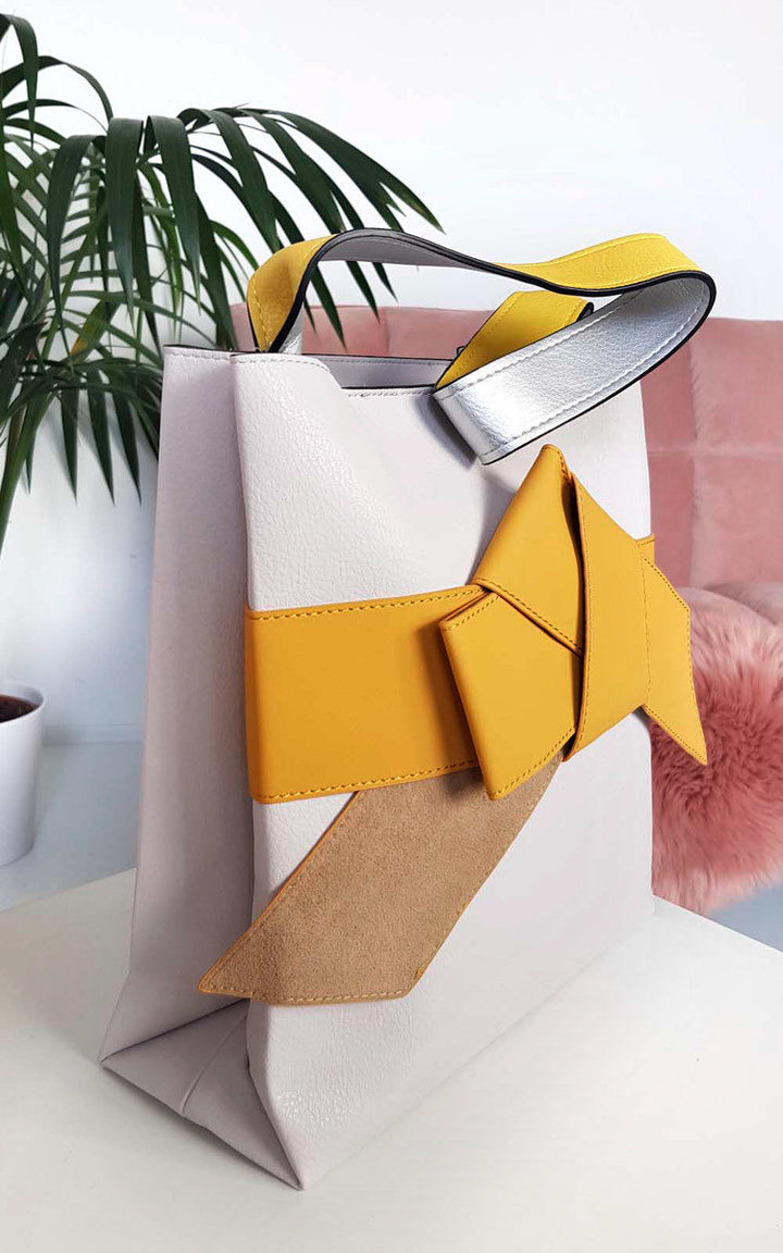 Colour Block Bow Tote Handbag featuring a sleek design with a statement bow on the front, perfect for stylish everyday use.