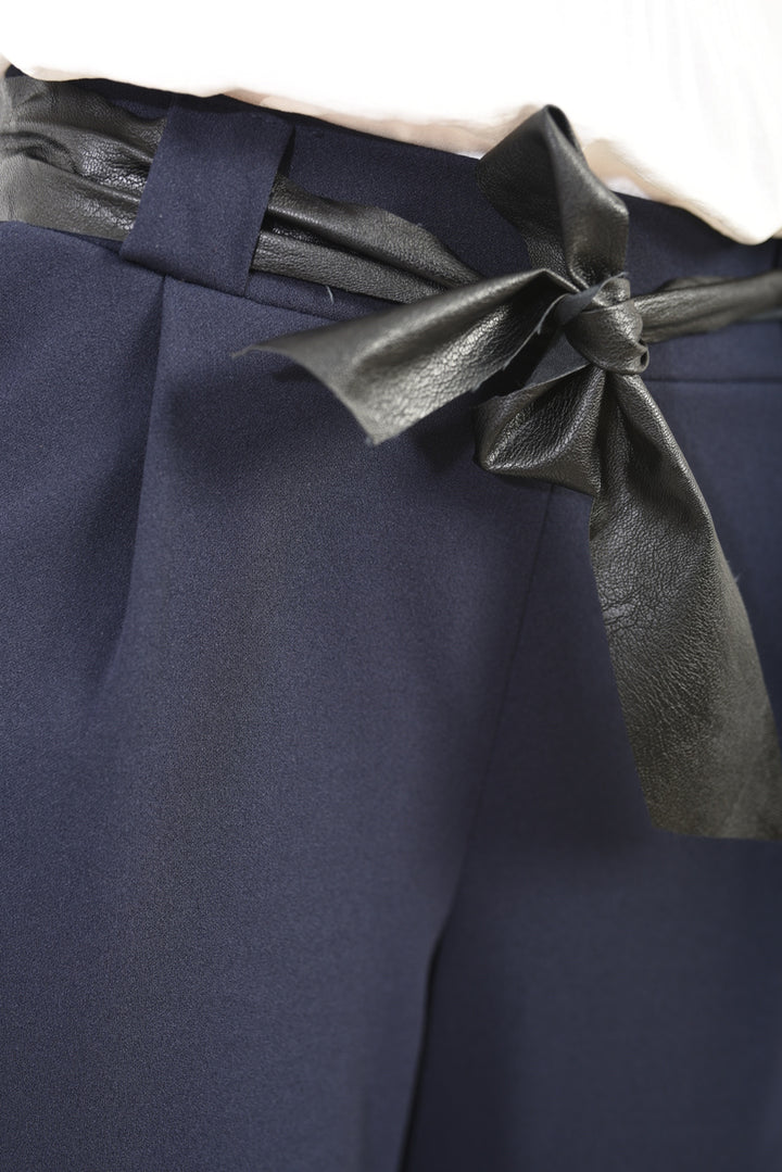 Close-up of the Belted High Waist Wide Leg Trouser, highlighting the elegant black bow accent on the waistband for a chic silhouette.