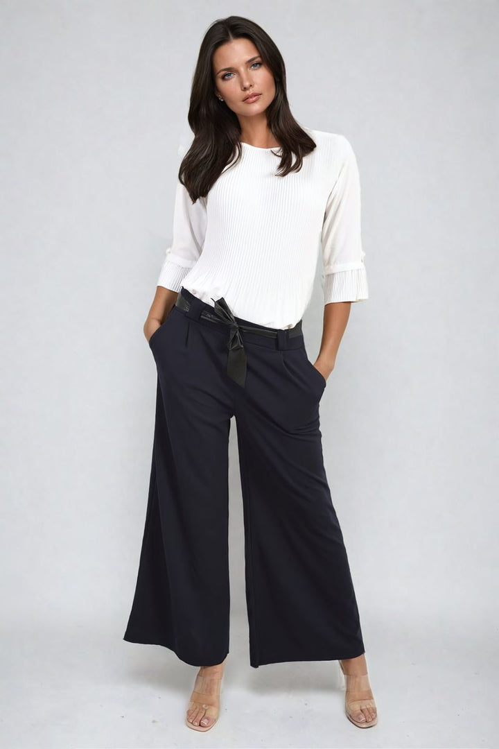 Belted High Waist Wide Leg Trouser featuring a flattering high waist and trendy wide legs, modeled by a woman wearing a white shirt, showcasing chic style.