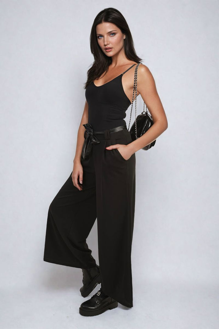 Woman wearing Belted High Waist Wide Leg Trousers, showcasing the stylish, high-waisted design and wide leg fit. Perfect for versatile holiday and everyday wear.