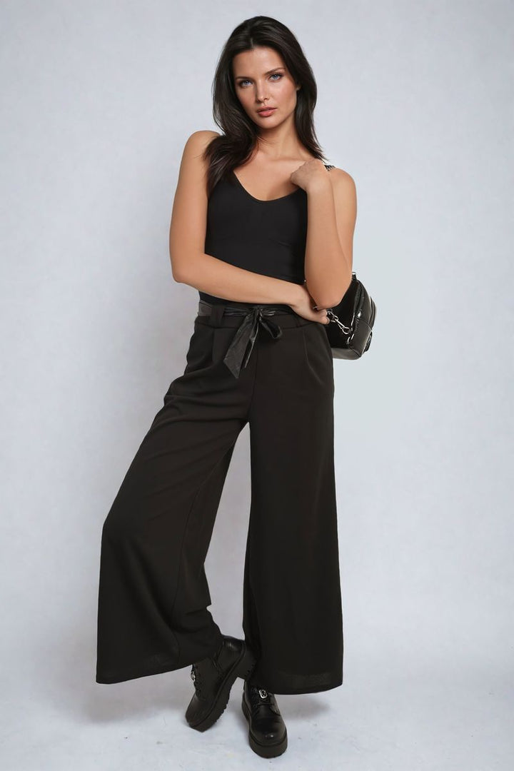 Woman modeling Belted High Waist Wide Leg Trouser, featuring a high waist and wide legs. The trousers provide a chic silhouette, suitable for various occasions.