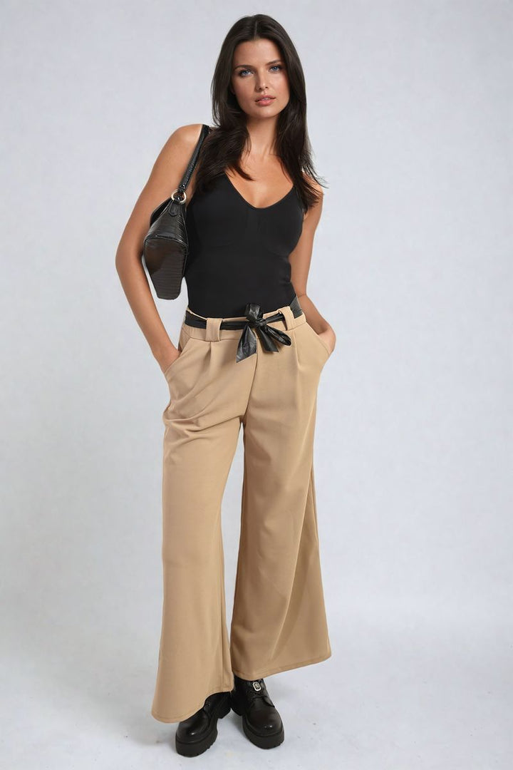 Woman wearing Mariana Belted High Waist Wide Leg Trousers in a casual setting, showcasing the trendy wide-leg style and high-waist belt feature.