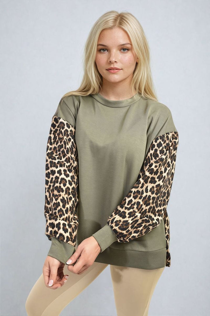 Woman wearing the Marissa Leopard Print Long Sleeve Knitted Jumper, showcasing its bold pattern and cozy design, ideal for stylish warmth.