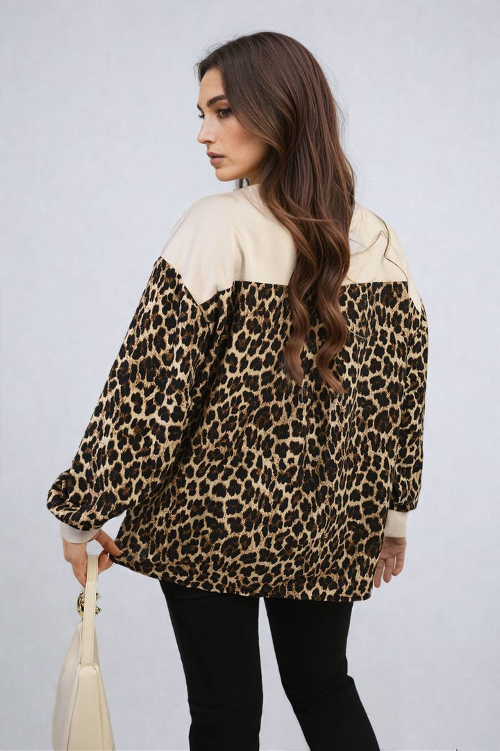 Woman wearing Marissa Leopard Print Long Sleeve Knitted Jumper, featuring a bold leopard pattern and cozy long sleeves, ideal for stylish warmth.