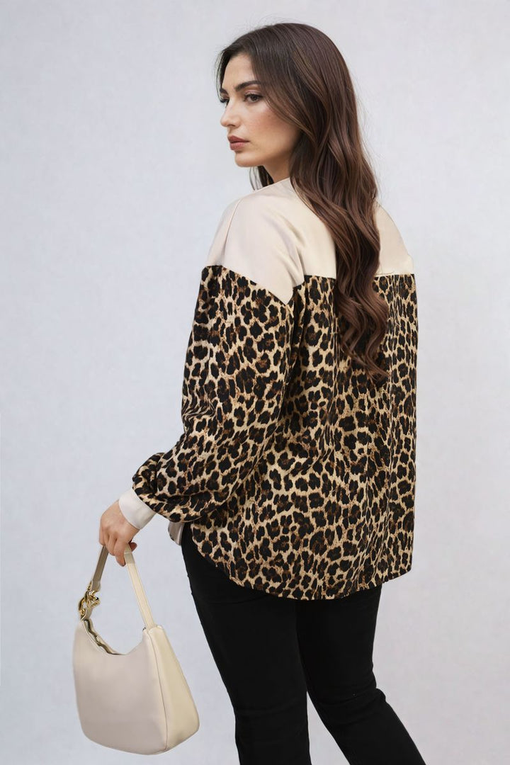 Woman wearing the Marissa Leopard Print Long Sleeve Knitted Jumper, paired with black pants, showcasing a stylish and cozy look for chilly days.