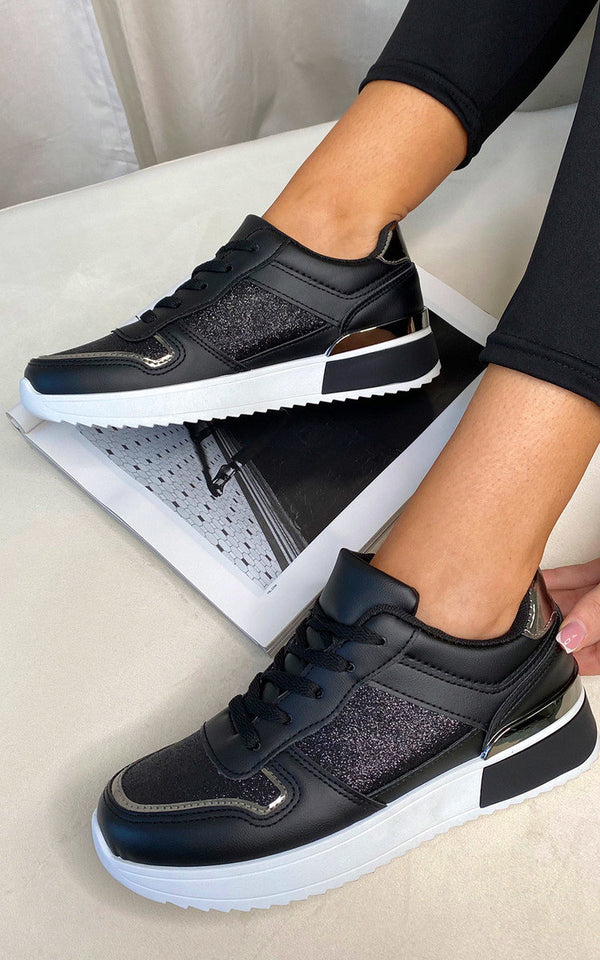 Faux Leather Trainer with Sparkle Detail, showcasing black and white design, worn by a person, highlighting its edgy style and comfort for active, fashion-conscious women.