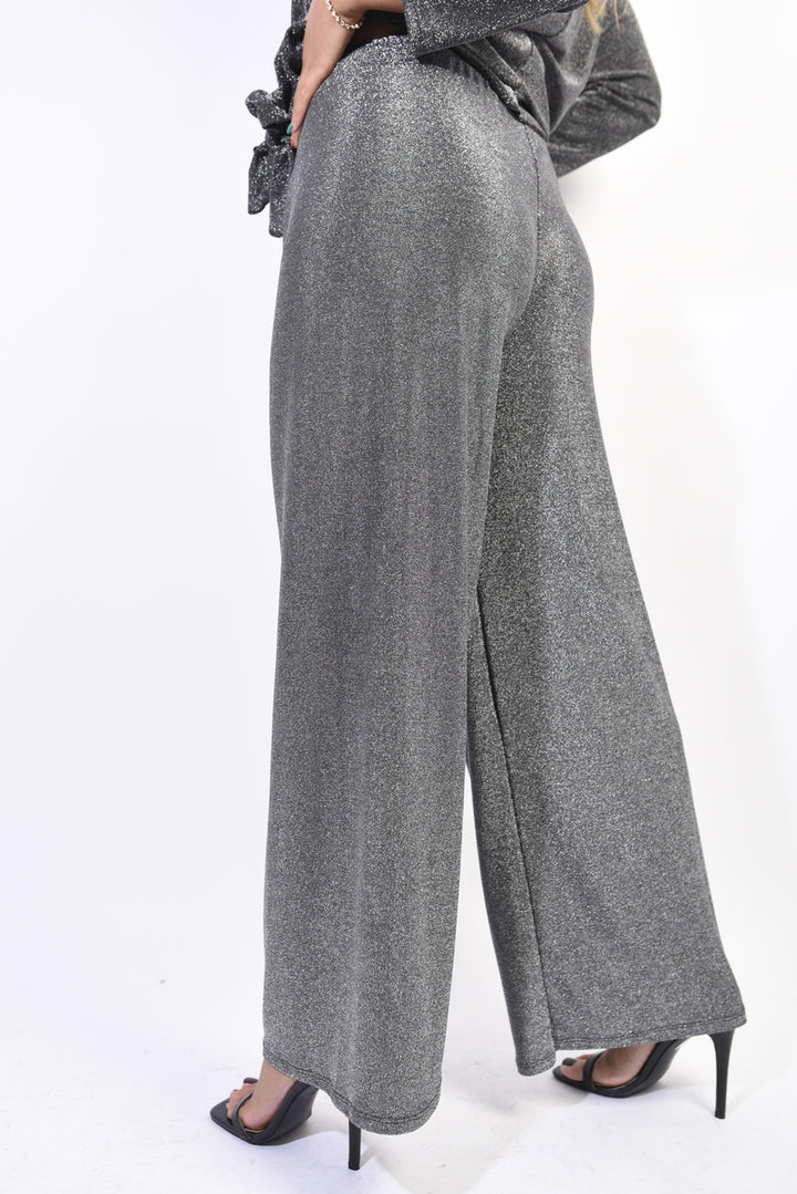 Woman wearing Matilda Wide Leg Trouser, showcasing its wide-leg design and stylish waistband detail, ideal for versatile fashion-forward comfort.